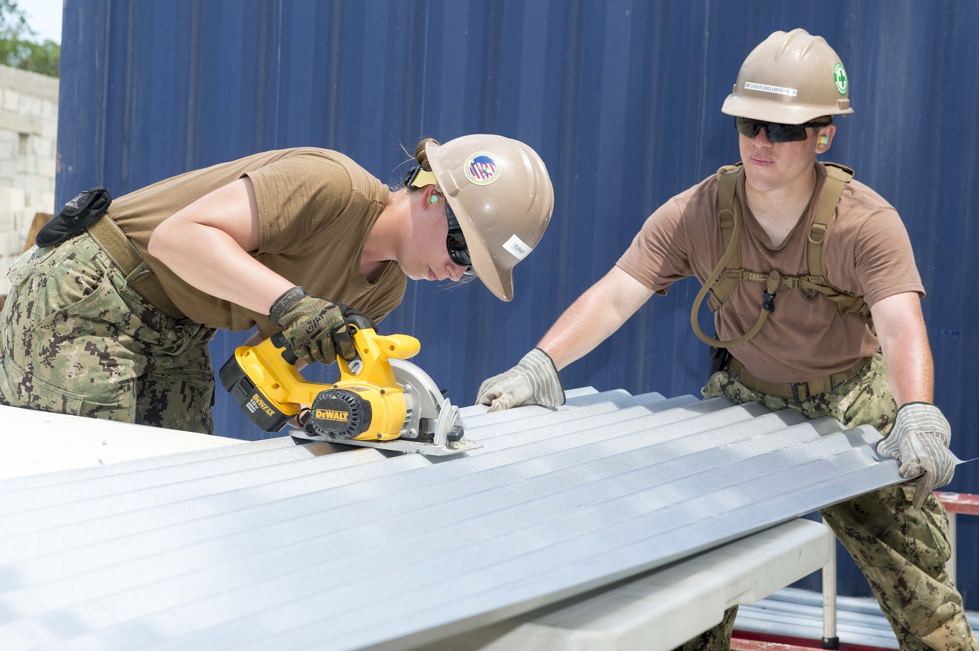 Women in trades cutting sheet metal